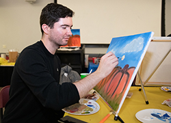 Student in an art class painting