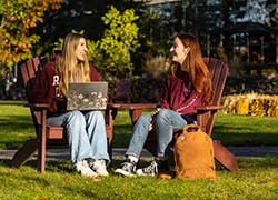 students sitting outside on campus