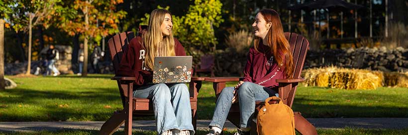 students sitting outside on campus